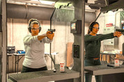 Two women shooting at indoor range